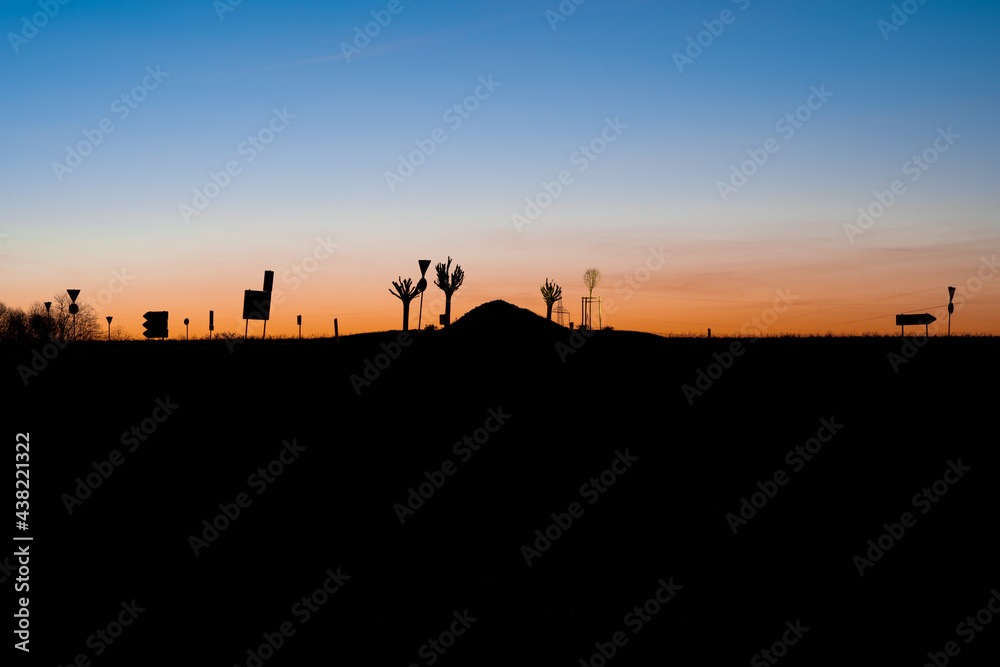 Sunset over hills and signs in the landscape