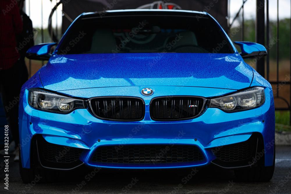Blue BMW M4 F83 wrapped in blue chrome wrap vinyl on Drift And Car Show.  Luxury German vehicle with led headlights and wide body kit Stock Photo |  Adobe Stock