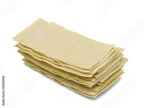 uncooked stacked lasagne sheets isolated on white background