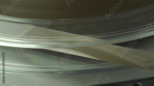 4k macro of tape reel spinning on a vintage audio recorder