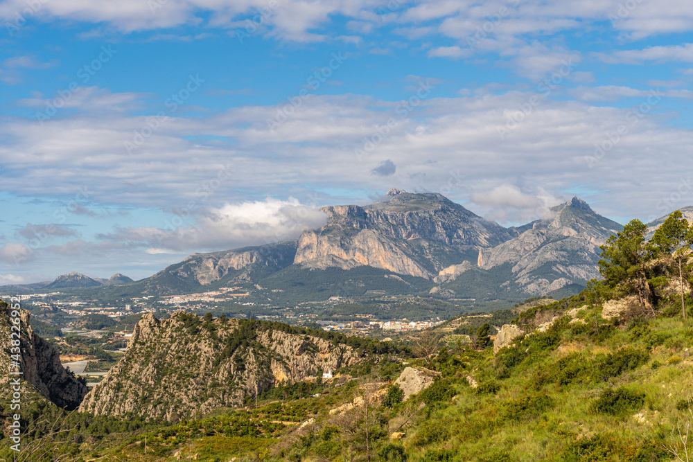 Landscape with steep mountains, on a cloudy day, in the interior of the province of Alicante (Spain)