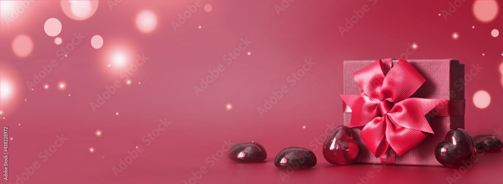Valentine's day concept banner with hand made gift box, bow, and a lot of hearts on a red background with space for text. Valentine's day concept banner with hand made gift box, bow, and a lot of hearts on a red background with space for text.