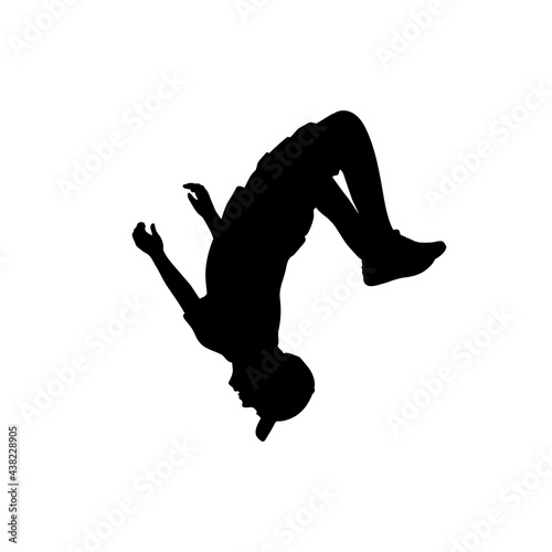 Silhouette teenager jumping flip. Somersault sport acrobatics. photo