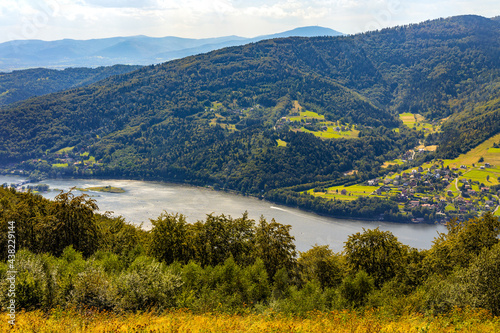 Panoramic view of Beskidy Mountains surrounding over Miedzybrodzkie Lake seen from Gora Zar mountain near Zywiec in Silesia region of Poland photo