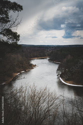 landscape photo of a river with stormy clouds above