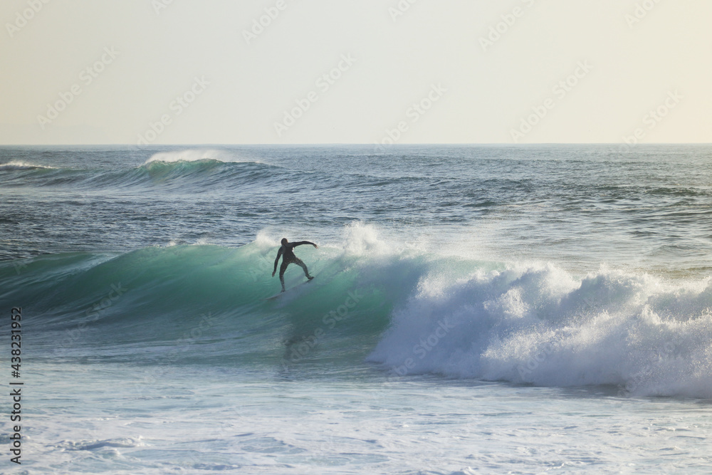 Surfer on Blue Ocean Wave . Surf spot in Ericeira Portugal.