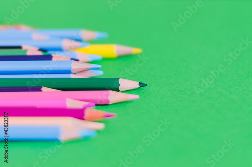 Color pencils on colored background, top right view with space for text. Back to school concept copy space for text