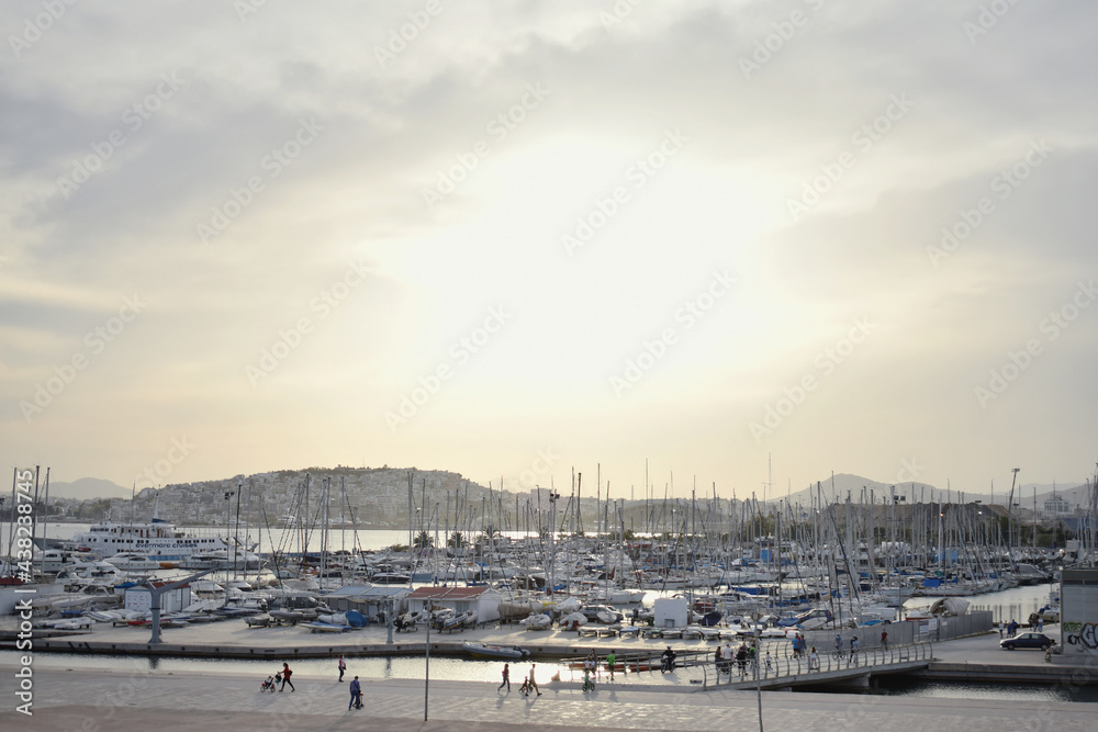 View of Marina Flisvos at Palaio Faliro, Athens (located behind of Stavros Niarchos Foundation Cultural Center). Marina with boats and people. May 2021 View of Marina Flisvos at Palaio Faliro, Athens (located behind of Stavros Niarchos Foundation Cultural Center). Marina with boats and people. May 2021