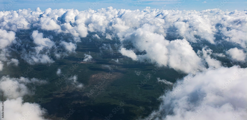 Aerial view of clouds over green areas