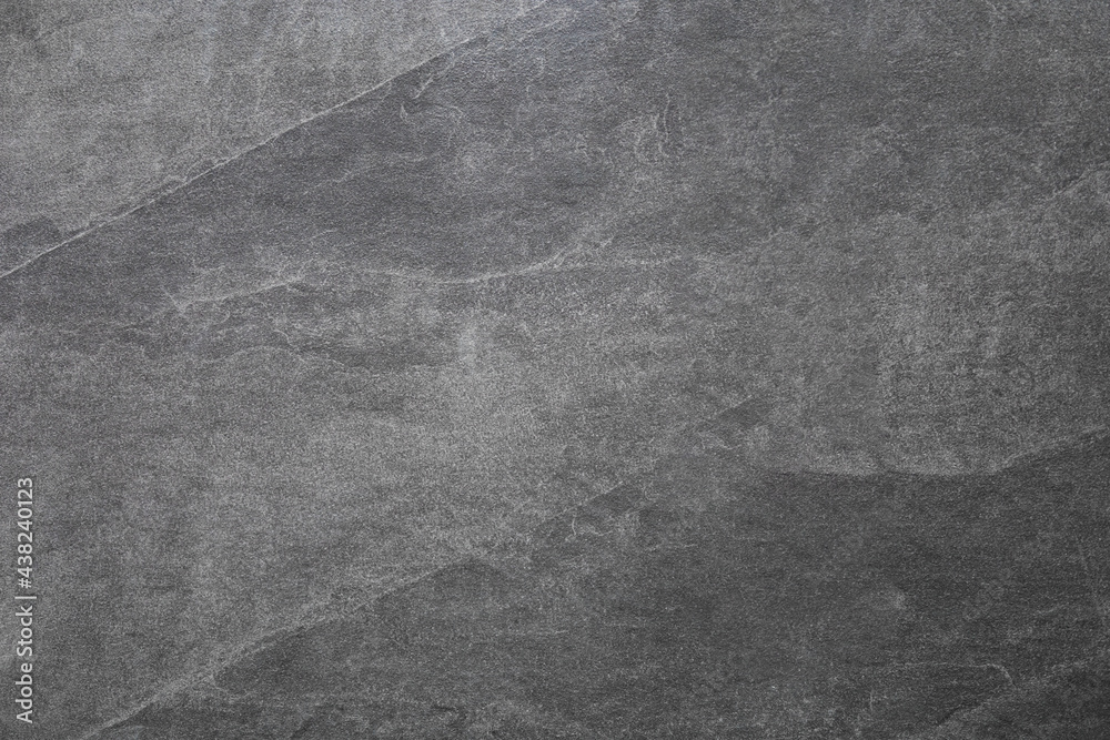 Fototapeta premium Dark grey stone wall texture . Gray rough backdrop. Stucco surface. Abstract pattern. Texture of natural granite. Abstract art creative background.