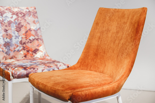 Orange contemporary armchairs with velour upholstery and white metal legs