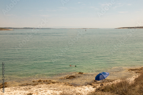 person on the beach in cape Kamenjak in Croatia photo