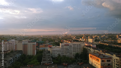 Evening sunlight falls on a large industrial city. Panorama
