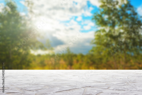 textured white surfaceon against blurred sky and trees background photo