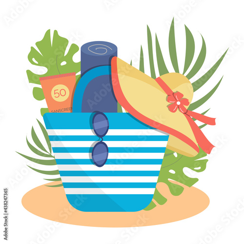 Striped beach bag with towel, sunblock, sunglasses