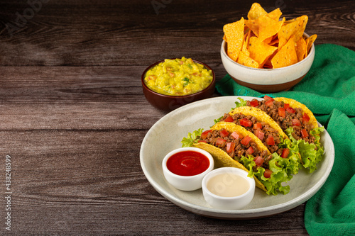 Mexican tacos with lettuce, beef and tomatoes.