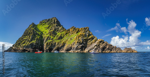 Large panorama with cruise boats docking to Skellig Michael island, where Star Wars were filmed, UNESCO World Heritage, Ring of Kerry, Ireland