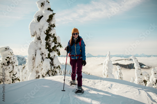 Person snowshoeing on pot of a mountain photo