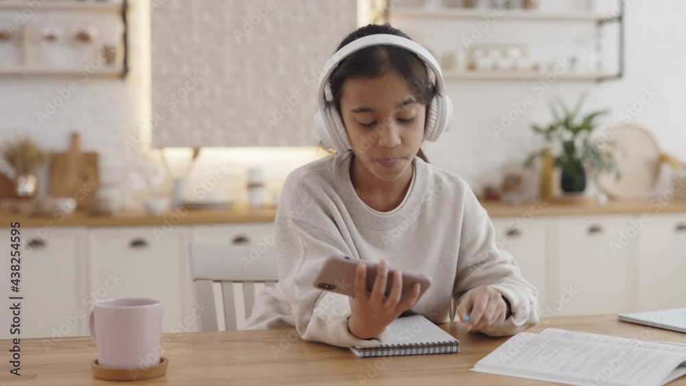 Child using headphones and smartphone for online education Child using headphones and smartphone for online education