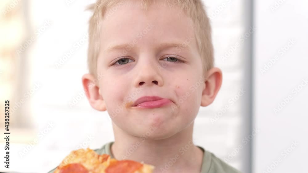 Portrait blonde boy Eating cheese Pizza Smiling close up. Happy Child
