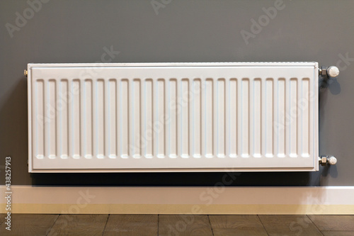 Wallpaper Mural White metal heating radiator mounted on gray wall inside a room. Torontodigital.ca