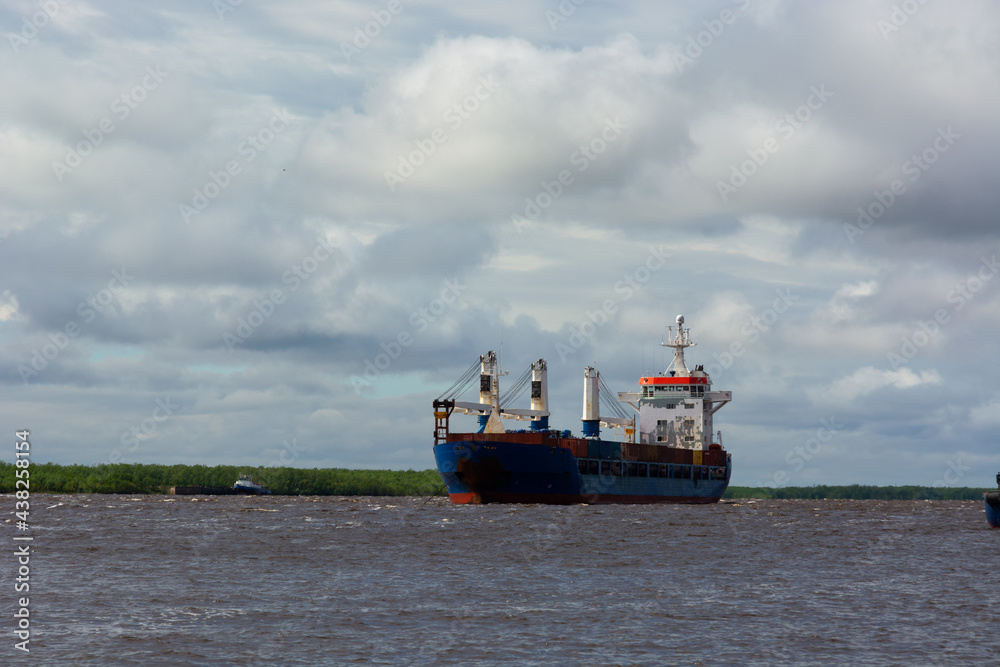 dry cargo ship on the roadstead on the Northern Dvina river. the concept of cargo transportation to anywhere in the world by water.