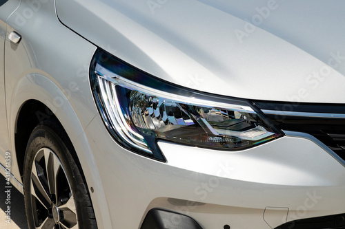Close up of a new car's headlight © artographer34