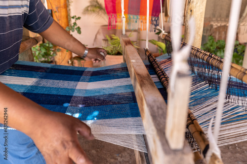textile hispanic weaver craftsman making products on a wooden handicraft loom - latinx photo
