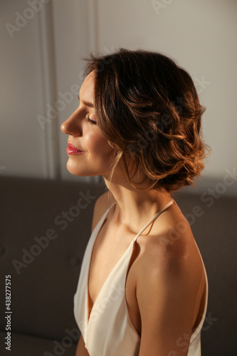 Elegant young woman with beautiful hairstyle indoors