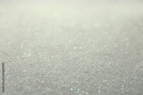 Shiny white glitter as background. Bokeh effect