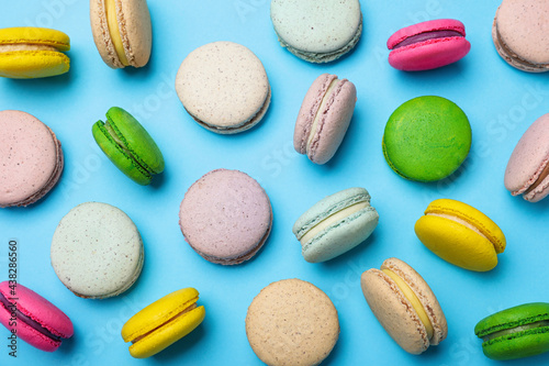 Wallpaper Mural Delicious colorful macarons on light blue background, flat lay Torontodigital.ca