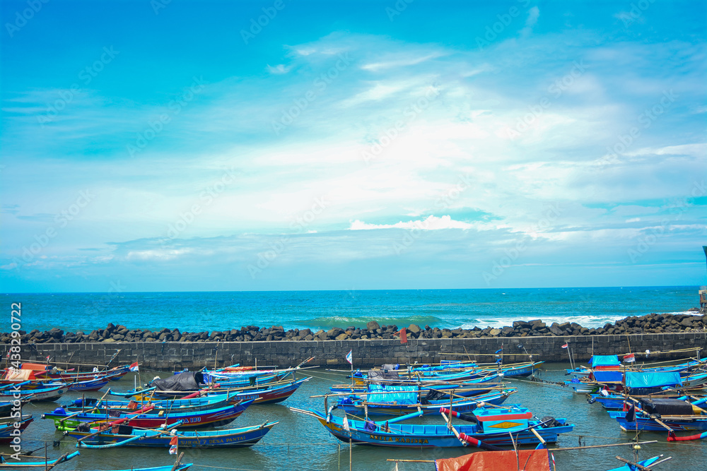 Indonesian sea view with fishing boats. Beautiful traditional fishing boats. Traditional people	