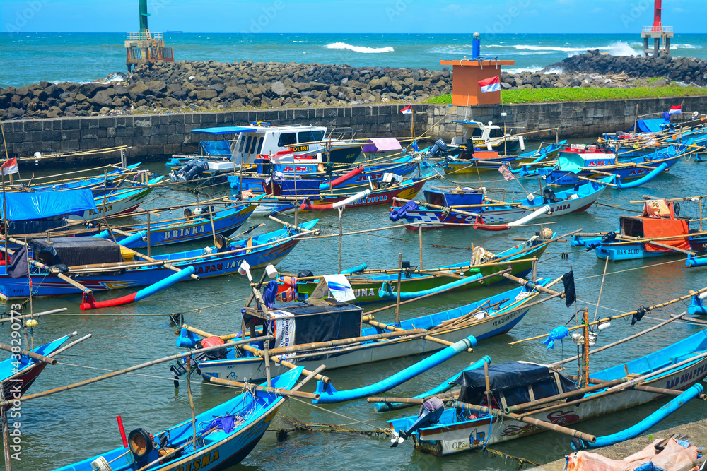 A view of fishing boats in the Indonesian sea. Beautiful traditional fishing boats. Traditional people