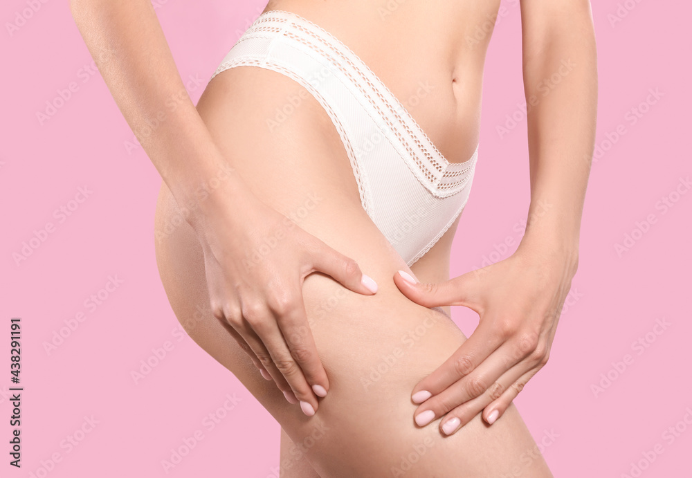 Closeup view of slim woman in underwear on pink background. Cellulite problem concept