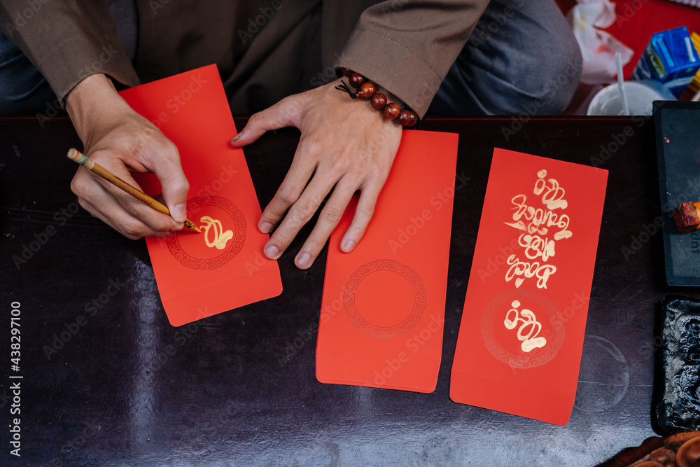 Vietnamese artist writes Tet calligraphy, Happy New Year in Vietnamese means (" Chuc mung nam