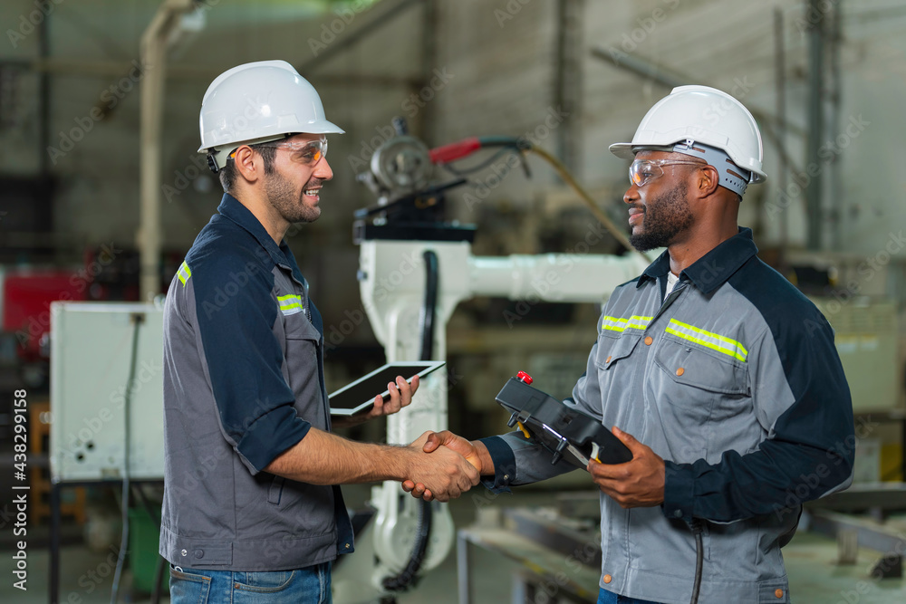 Two Industry engineers stand and discussion work in the factory workshop. Two Industry engineers stand and discussion work in the factory workshop.