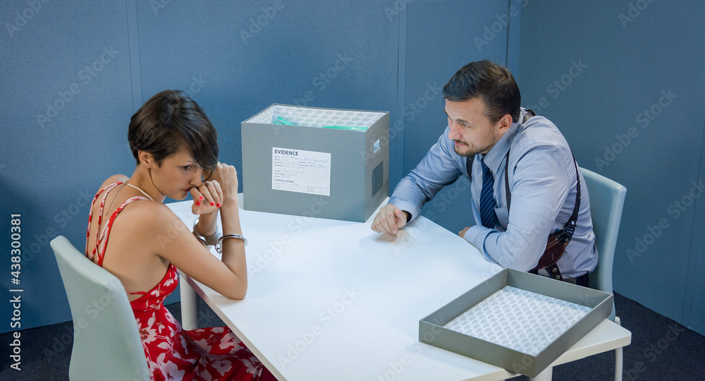 Detective brings in an interrogation room with a box of material ...