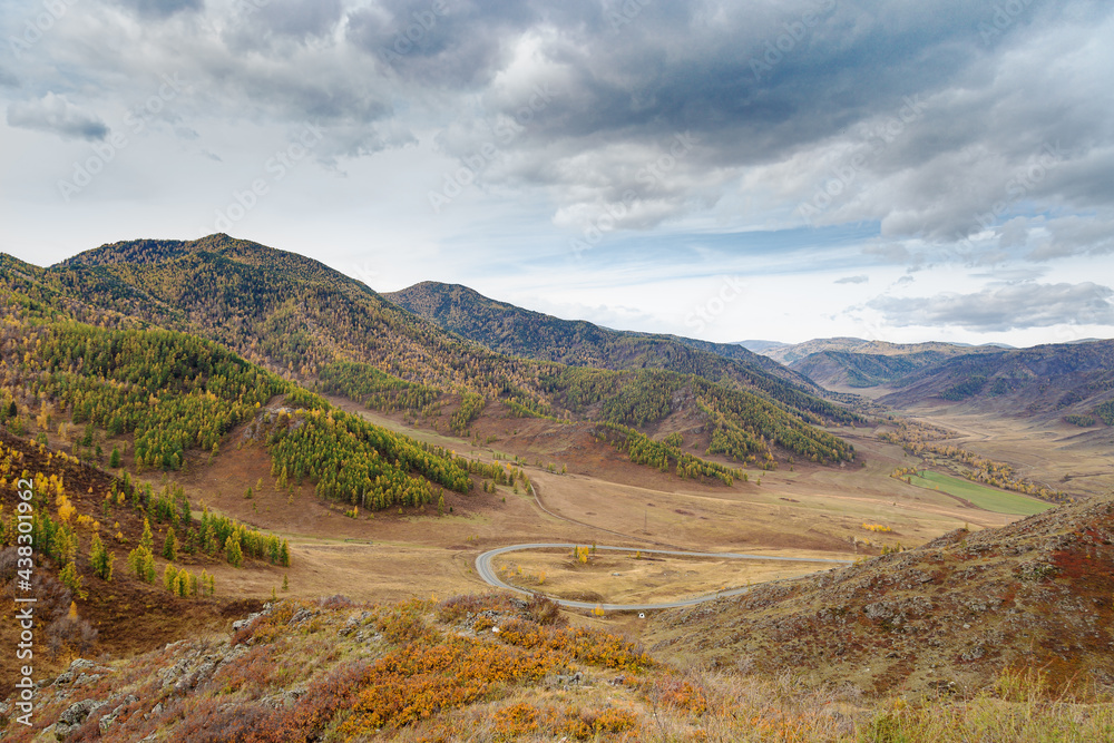 Beautiful view along Chuysky tract, Altai Republic, Russia, natural autumn landscape, mountains and blue cloudy sky, tourist trip by own car.