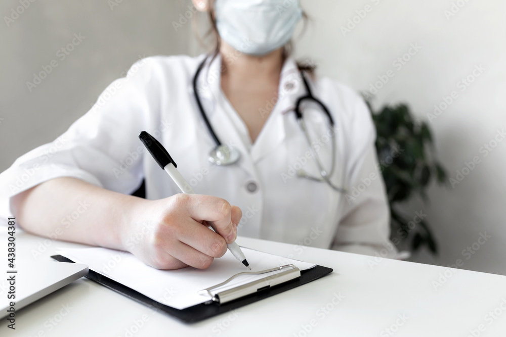 The doctor writes something in the patient's medical history The doctor writes something in the patient's medical history