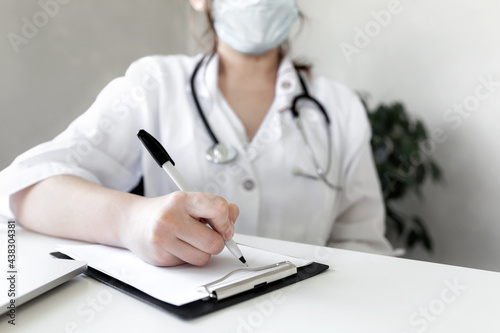 The doctor writes something in the patient's medical history