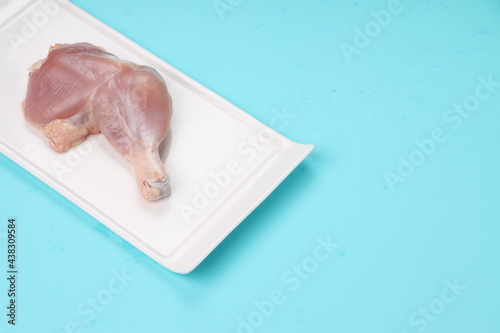 Raw whole chicken leg_grey board