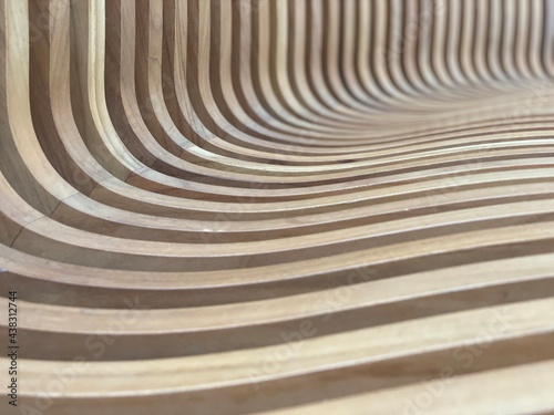 close up on the curves of this wood carved bench creating a wave of images