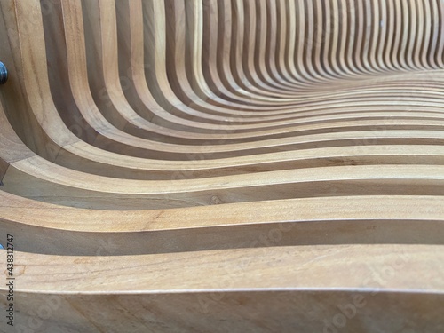 close up on the curves of this wood carved bench creating a wave of images