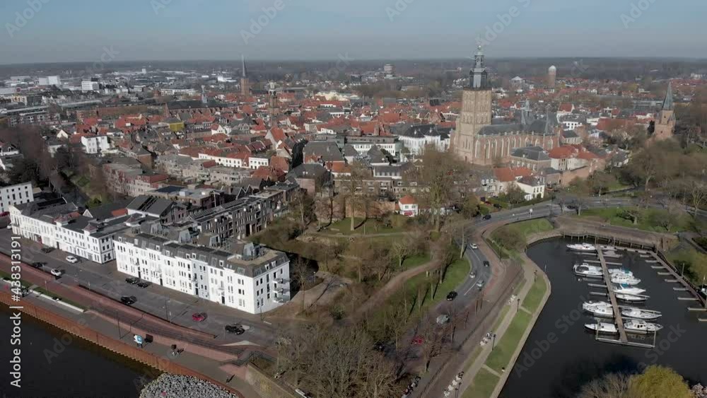 Ascending aerial view of picturesque medieval Hanseatic city Zutphen, The Netherlands, with entrance to small Vispoorthaven or Gelre port along river IJssel against a blue sky Ascending aerial view of picturesque medieval Hanseatic city Zutphen, The Netherlands, with entrance to small Vispoorthaven or Gelre port along river IJssel against a blue sky