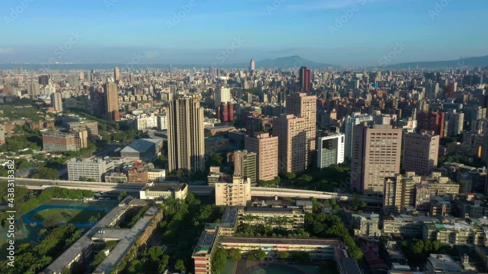 Aerial flyover capital city of Taipei in Taiwan during sunset and blue sky. City center downtown with skyscraper and high rise buildings. Aerial flyover capital city of Taipei in Taiwan during sunset and blue sky. City center downtown with skyscraper and high rise buildings.