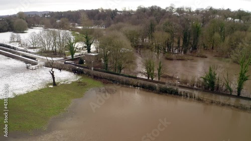 Aerial footage from Drone showing the river Bollin in Wilmslow, Cheshire after heavy rain and with burst banks and flooding surrounding area. England, UK photo