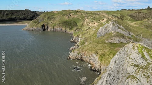 Limestone Sea Cliffs At Summer Near Three Cliffs Bay Beach In Swansea, Wales, United Kingdom. - aerial photo