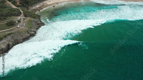 Birdseye drone shot of surfers at Tofinho Point, Mozambique. photo