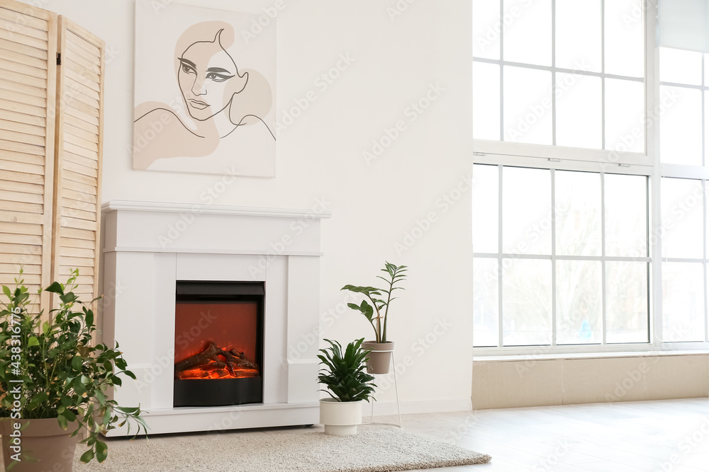 Fototapeta premium Stylish fireplace in interior of living room