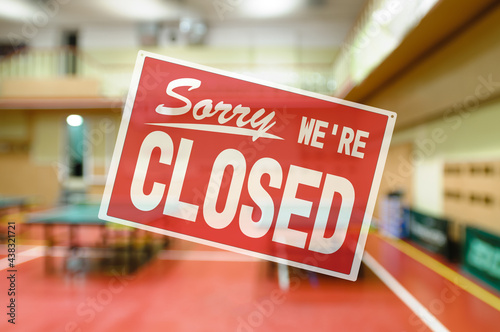 inscription sorry we are closed. introducing forbidden measures for attending group classes. Naturally blurred interior of modern gym with tables for ping-pong